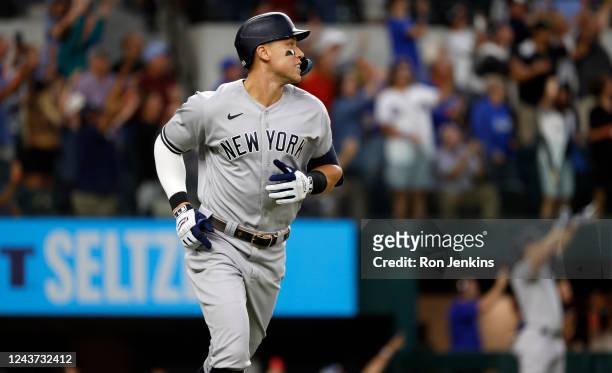 Aaron Judge of the New York Yankees rounds the bases after hitting his 62nd home run of the season against the Texas Rangers during the first inning...