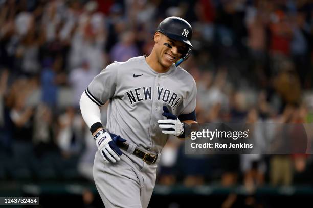 Aaron Judge of the New York Yankees smiles as he rounds the bases after hitting his 62nd home run of the season against the Texas Rangers during the...