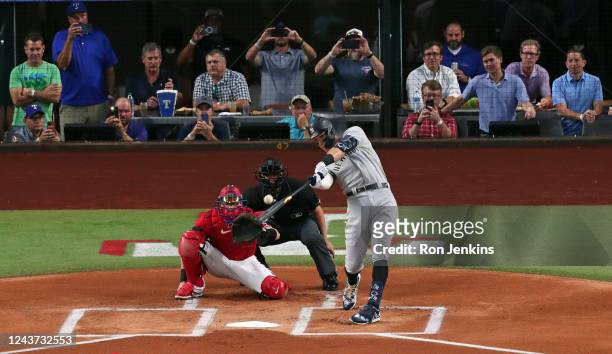Aaron Judge of the New York Yankees hits his 62nd home run of the season against the Texas Rangers during the first inning in game two of a double...