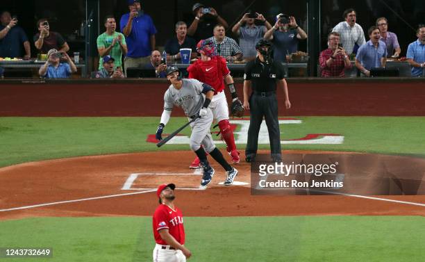 Aaron Judge of the New York Yankees watches his 62nd home run of the season against the Texas Rangers during the first inning in game two of a double...