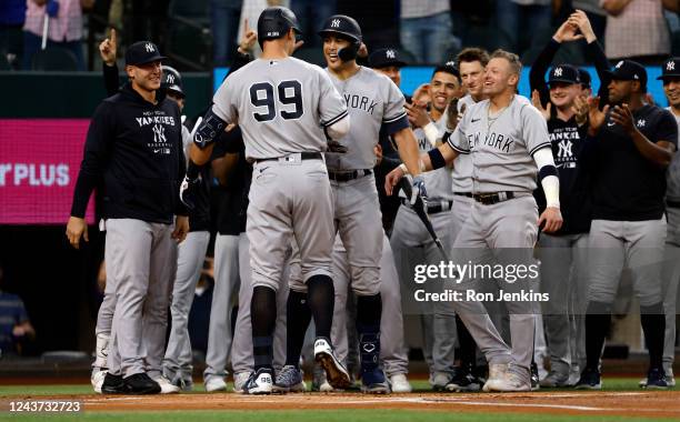 Aaron Judge of the New York Yankees celebrates with teammates after hitting his 62nd home run of the season against the Texas Rangers during the...