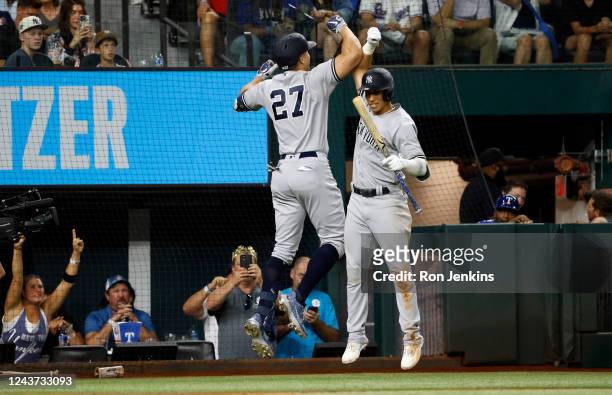 Giancarlo Stanton of the New York Yankees celebrates with teammate Oswaldo Cabrera after Stanton's solo home run against the Texas Rangers during the...