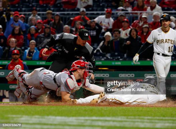 Andrew Knizner of the St. Louis Cardinals tags out Kevin Newman of the Pittsburgh Pirates in the tenth inning during the game at PNC Park on October...