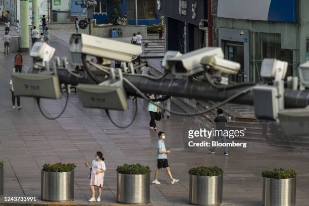 Pedestrians pass security cameras at a major shopping district in Chongqing, China, on Wednesday, Aug. 17, 2022. When President Xi Jinping took power...