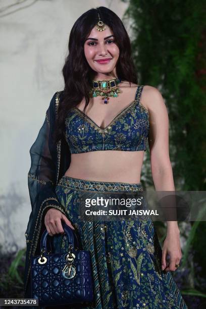 In this picture taken on October 4 Bollywood actress Amyra Dastur poses for pictures during the wedding reception of actors Richa Chadha and Ali...