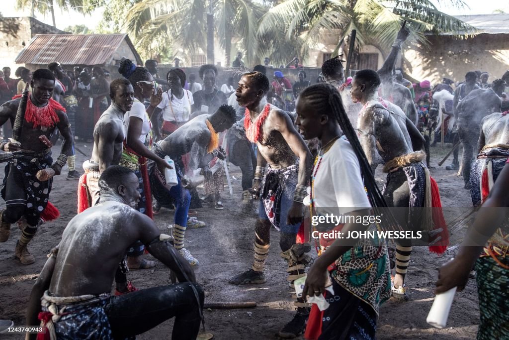 Young Men Perform To Show Their Strength As Girls Cheer During A young-men-perform-to-show-their-strength-as-girls-cheer-during-a
