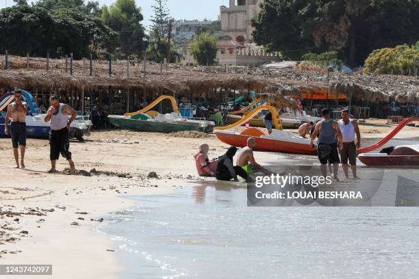 Syrians spend time at the beach in the northern Mediterranean city of Latakia, on October 4, 2022.