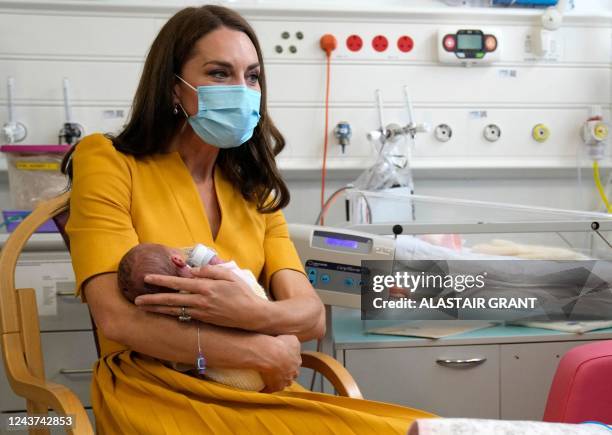 Britain's Catherine, Princess of Wales, wearing a face mask to help mitigate the possible spread of Covid-19, speaks to mew mother Sylvia Novak ,...