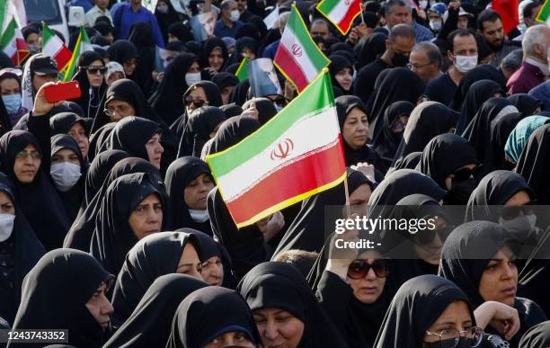 Iranians take part in a pro-government rally in Tajrish square north of Tehran, on October 5 condemning recent anti-government protests over the...