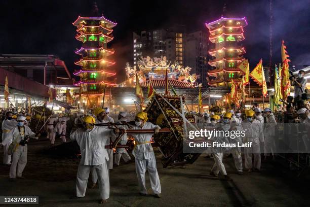 Malaysian Chinese devotees carry a statue as they dance during The Nine Emperor Gods Festival inside the Kau Ong Ya Temple. Taoists of Malaysia...