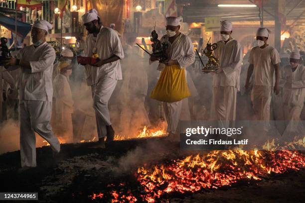 Malaysian Chinese devotees walk on burning charcoal during The Nine Emperor Gods Festival inside the Kau Ong Ya Temple. Taoists of Malaysia celebrate...