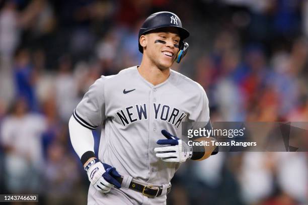 Aaron Judge of the New York Yankees smiles as he rounds the bases after hitting his 62nd home run of the season against the Texas Rangers during the...