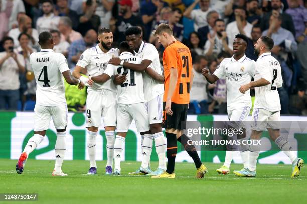 Real Madrid's Brazilian forward Rodrygo celebrates with teammates scoring his team's first goal during the UEFA Champions League 1st round day 3...