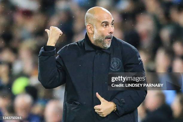 Manchester City's Spanish manager Pep Guardiola celebrates after Manchester City's Norwegian striker Erling Haaland scored his team second goal...