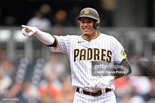 Manny Machado of the San Diego Padres points back to the dugout after hitting a double during the first inning of a baseball game against the San...