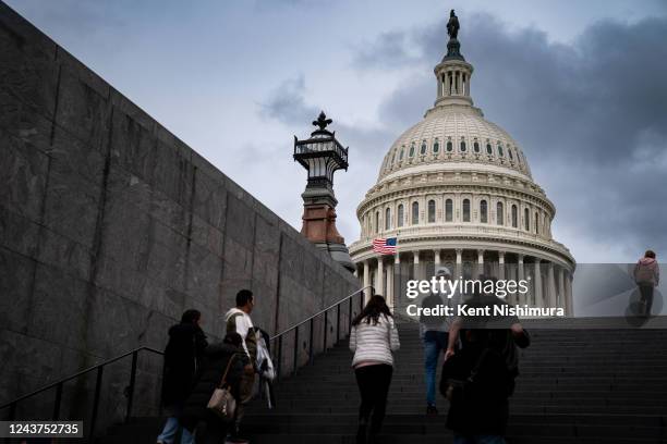 Visitors are cast in silhouette at the top of stairs near the Capitol Visitors Center at the United States Capitol on Wednesday, Oct. 5, 2022 in...