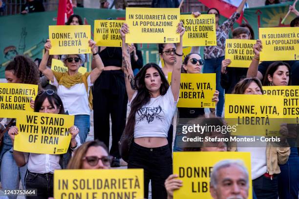 Protesters hold sign during a demonstration by Amnesty International Italy in defence of Iranian women and protestors in Iran in Piazza del...