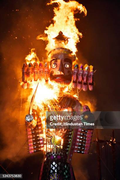 People watch the burning of the effigy of demon king Ravana during the Dussehra festival celebration at Shri Dharmik Leela Committee, at the Red Fort...