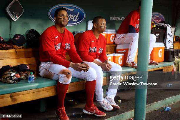 Rafael Devers of the Boston Red Sox and Xander Bogaerts, left, in the dugout during the fourth inning of the game against the Tampa Bay Rays at...