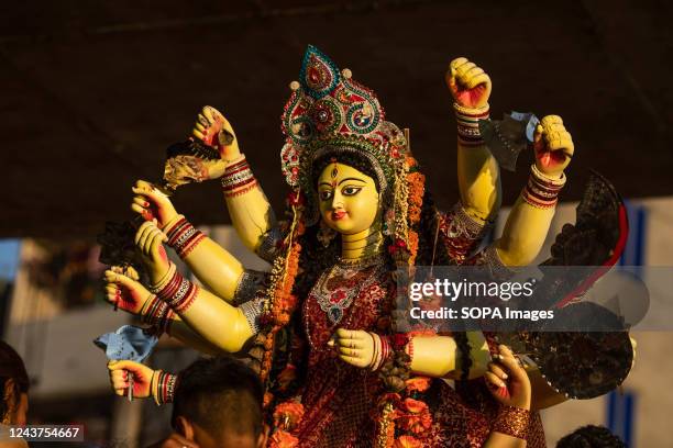 Hindu devotees carry an idol of the goddess Durga during the final day of Durga Puja festival. The four-day long Durga Festival is celebrated across...