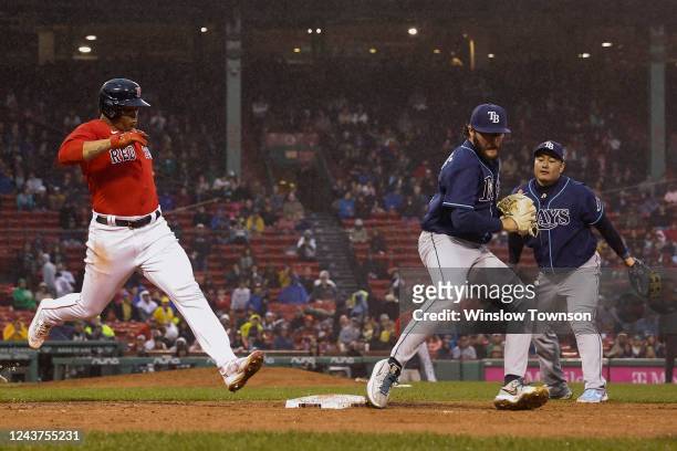 Pitcher Josh Fleming of the Tampa Bay Rays beats Rafael Devers of the Boston Red Sox to the bag for the out during the fifth inning at Fenway Park on...