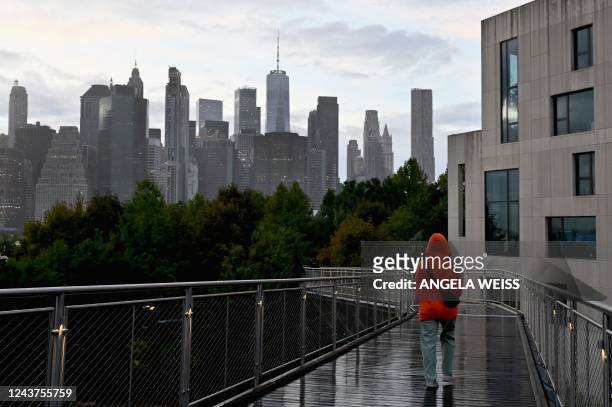 Person walks on a rainy afternoon near Brooklyn Bridge Park on October 5, 2022 in New York City.
