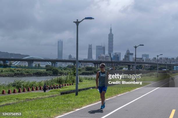 Man runs past the Taipei skyline in Taoyuan, Taiwan, on Wednesday, Oct. 5, 2022. Taiwan warned it would treat any Chinese incursion into the island's...