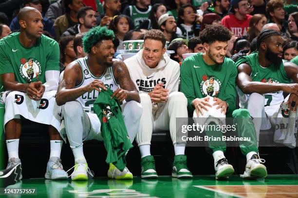 Marcus Smart and Blake Griffin of the Boston Celtics laugh on the bench during the game against the Toronto Raptors on October 5, 2022 at the TD...