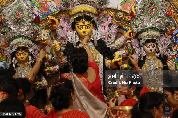 An Indian Hindu devotee worships an idol of the goddess Durga as part of a ritual on the last day of Vijaya Dashami celebrated during Durga Puja...