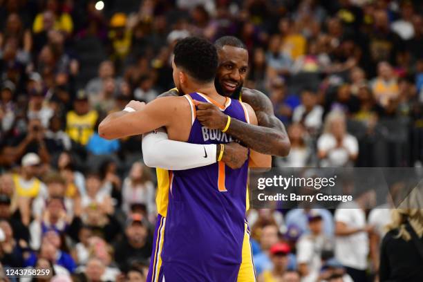 LeBron James of the Los Angeles Lakers hugs Devin Booker of the Phoenix Suns before a preseason game on October 5, 2022 at T-Mobile Arena, Las Vegas,...