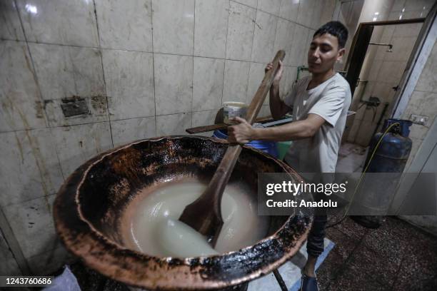 Worker of sweet production business mixing ingredients and prepare candies ahead of Mawlid al-Nabi as people share tradition of gifting candies to...