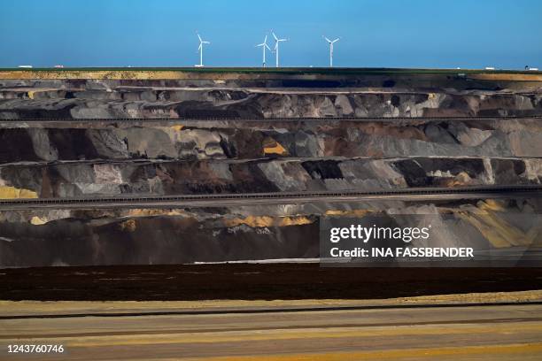 Picture taken on October 5, 2022 shows wind turbines behind the Garzweiler lignite open cast mine operated by German energy giant RWE near...