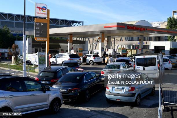 Drivers line up as they wait at a TotalEnergies fuel station in Marseille, southern France on October 06, 2022. - No general shortage, but more than...