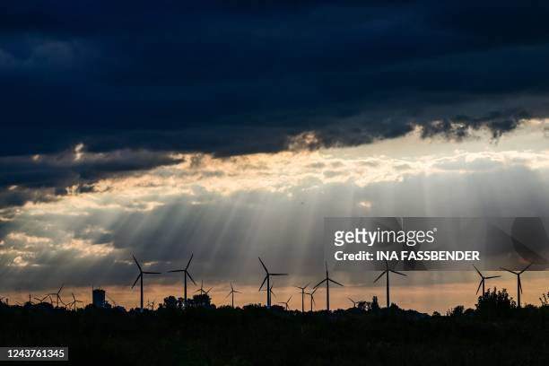 Picture taken on October 5, 2022 shows wind turbines at the Garzweiler lignite open cast mine operated by German energy giant RWE near Luetzerath,...