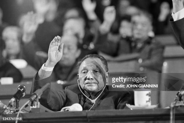 Leader of the People's Republic of China Deng Xiaoping raises hand for vote, on November 1, 1987 in Beijing, at the closing meeting of the 13th...