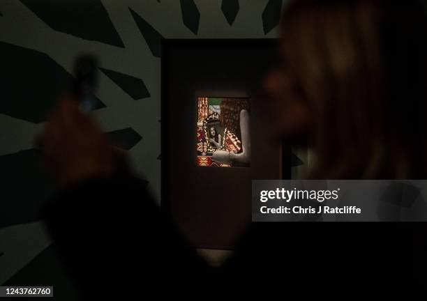 Guests view miniatures of female icons by artist Sohella Sokhanvari during a preview at the Barcian on October 6, 2022 in London, England. This is...