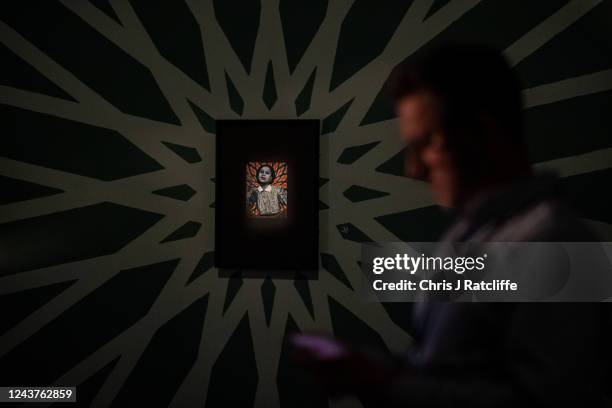 Guests view miniatures of female icons by artist Sohella Sokhanvari during a preview at the Barcian on October 6, 2022 in London, England. This is...