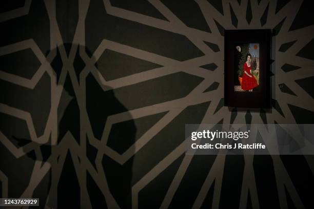 Guests view miniatures of female icons by artist Sohella Sokhanvari during a preview at the Barcian on October 6, 2022 in London, England. This is...