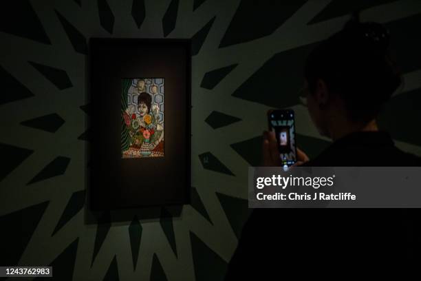 Guests view miniatures of female icons by artist Sohella Sokhanvari during a preview at the Barcian on October 6, 2022 in London, England. This is...