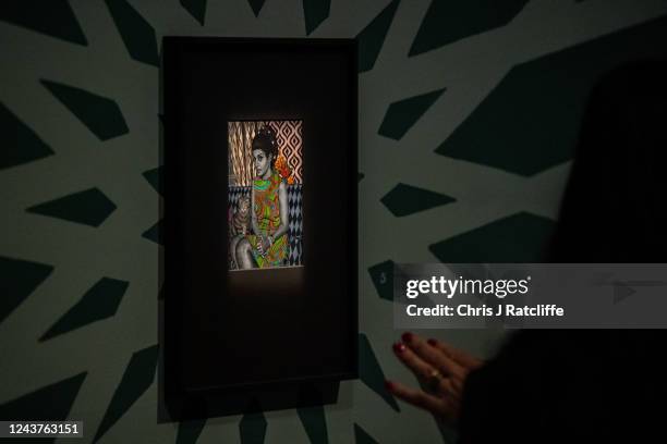 Guests view miniatures of female icons by artist Sohella Sokhanvari during a preview at the Barcian on October 6, 2022 in London, England. This is...