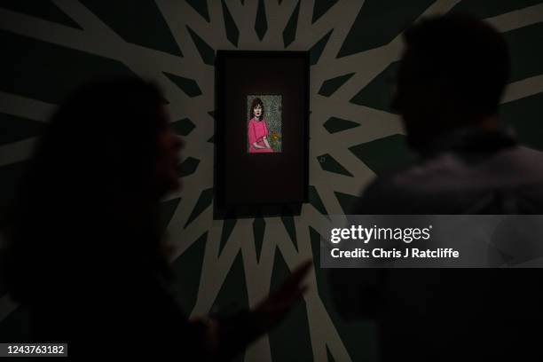 Guests view miniatures of female icons by artist Sohella Sokhanvari during a preview at the Barcian on October 6, 2022 in London, England. This is...