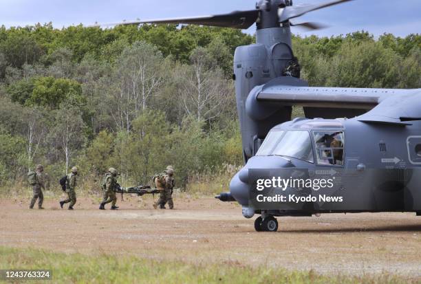 Japan Ground Self-Defense Force personnel take part in a joint drill with the U.S. Marine Corps using a U.S. Air Force CV22 Osprey tilt-rotor plane...