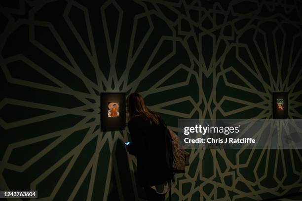 Guests view miniatures of female icons by artist Sohella Sokhanvari during a preview at the Barcian on October 6, 2022 in London, England. This is...