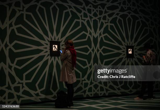 Guests view miniatures of female icons by artist Sohella Sokhanvari during a preview at the Barcian on October 6, 2022 in London, England. This is...