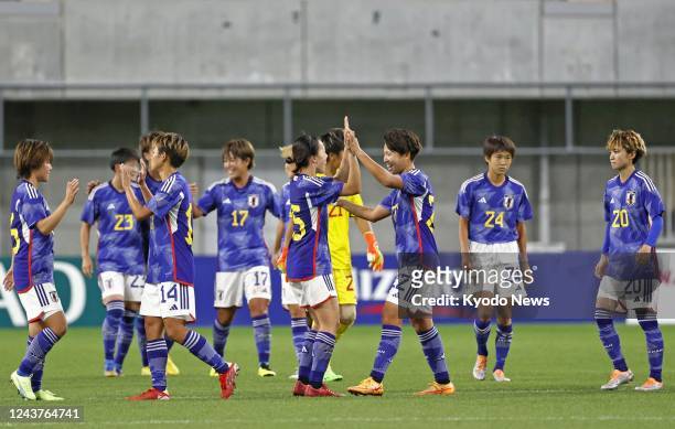 Japan's women's football team members celebrate after beating Nigeria 2-0 in an international friendly at Noevir Stadium in Kobe, western Japan, on...