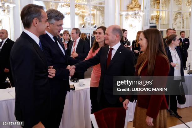 Greece's Prime Minister Kyriakos Mitsotakis speaks with German Chancellor Olaf Scholz , Prime Minister of of Croatia Andrej Plenkovic , Finnish Prime...