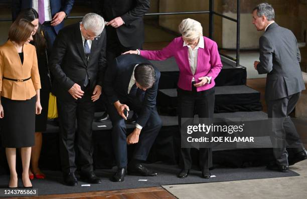 European Commission President Ursula von der Leyen , Netherlands' Prime Minister Mark Rutte and other participants take their positions as they...