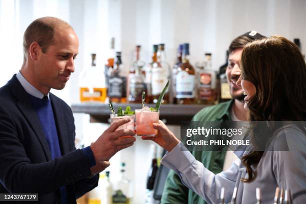 Britain's Catherine, Princess of Wales and Britain's Prince William, Prince of Wales drink a cocktail as they visit the Trademarket outdoor market in...