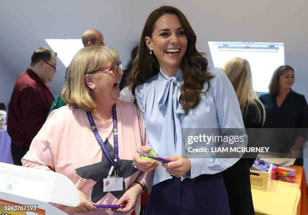 Britain's Catherine, Princess of Wales speaks as she meets with volunteers and members of staff during a visit to PIPS Suicide Prevention , in...