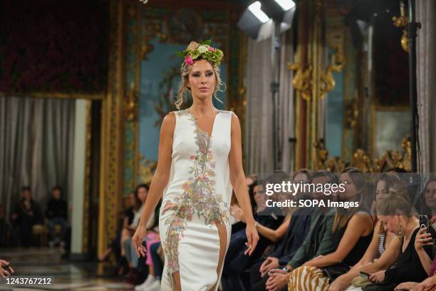 Model showcases a creation by Jordi Dalmau during the Atelier Couture bridal catwalk within Madrid Fashion Week, held at Santa Isabel Palace in...